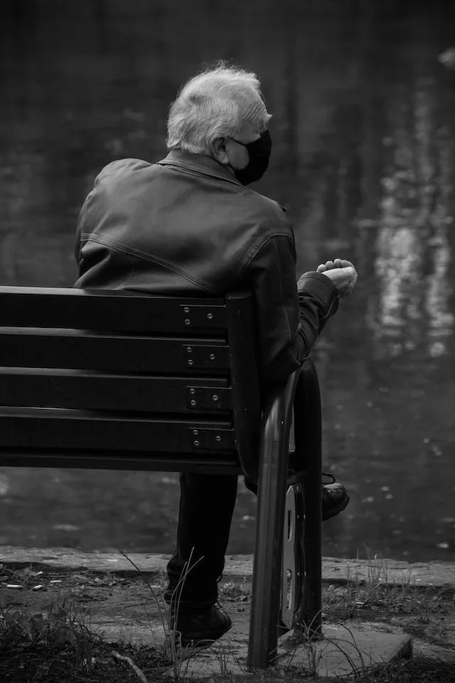 Elderly Man Sitting on a Bench