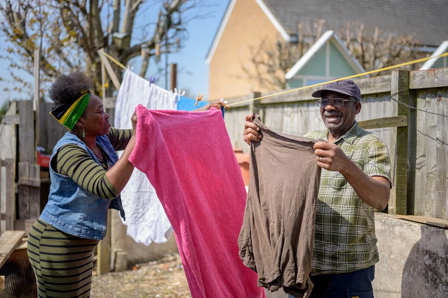 two people together washing clothes