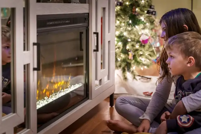 Kids sitting by the fire